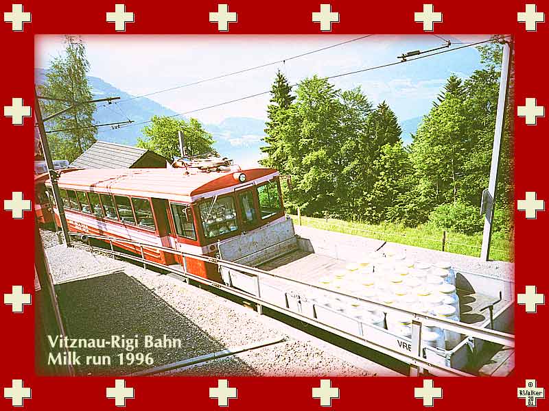 The Vitznau-Rigi Bahn milk run, 1996. Note the reflection of the milk cans in the windshield - looks like they are inside. These red trains ascend the Rigi mountain from a different side than the Arth-Goldau (blue) trains (not shown), but apparently are now operated by the same company.